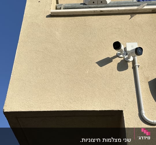 שתי מצלמות אבטחה מותקנות על קיר חיצוני